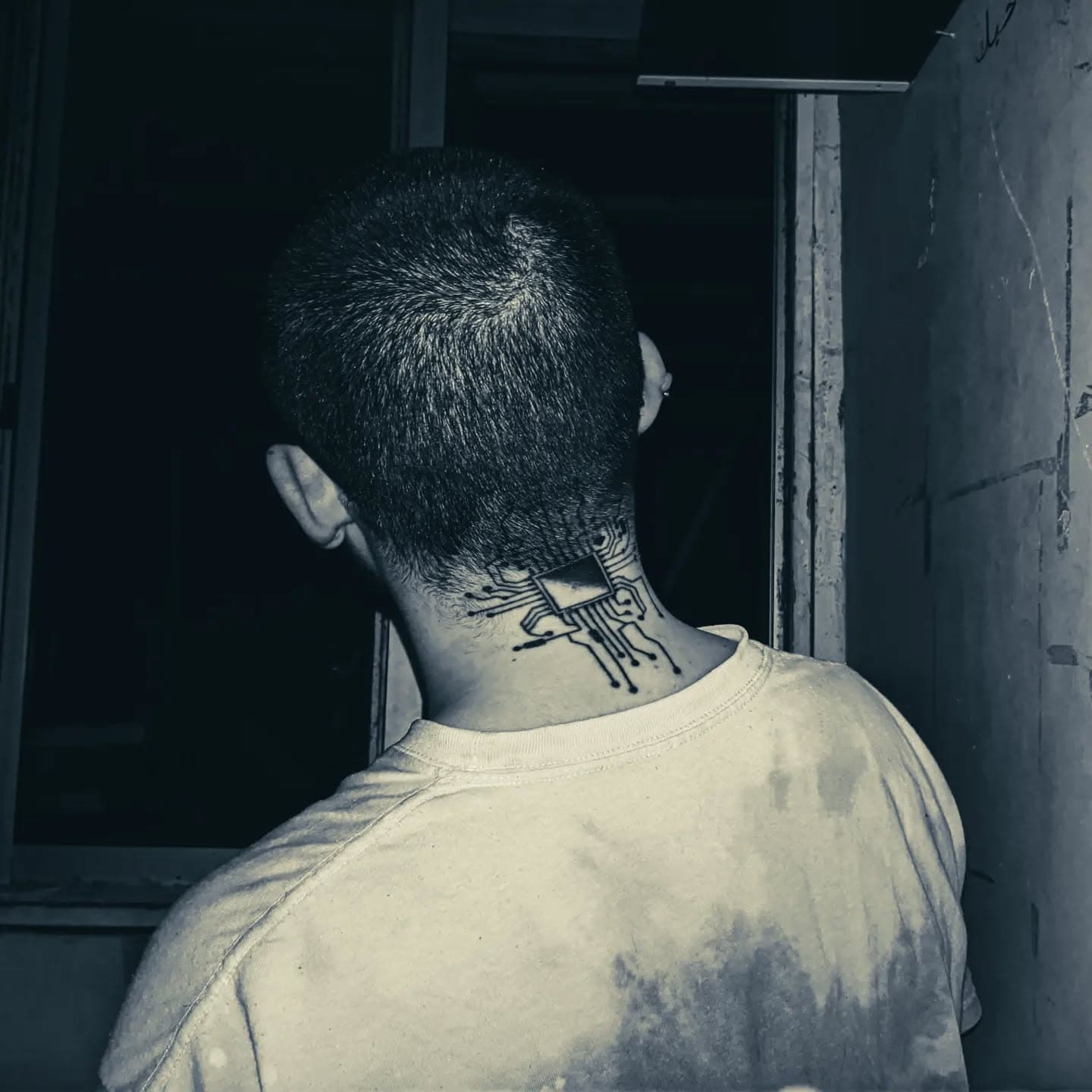Nico with a tattoo on the back of his neck: a CPU chip